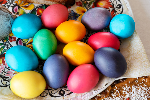 Hand painted colourful easter eggs on white background. Directly above table top shot.