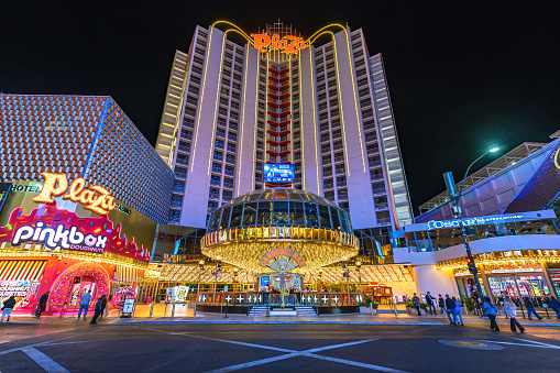 Las Vegas, Nevada, USA - November 10, 2023 : Night view of Plaza Hotel and Casino with vibrant lights on Fremont Street. Established in 1971, the Plaza Hotel is a historic icon of Las Vegas.