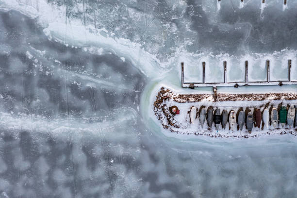 amazing winter sunset at frozen lake with rustic blue wooden boat