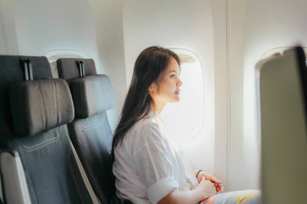 istock young woman on airplane using on board entertainment 1972747712