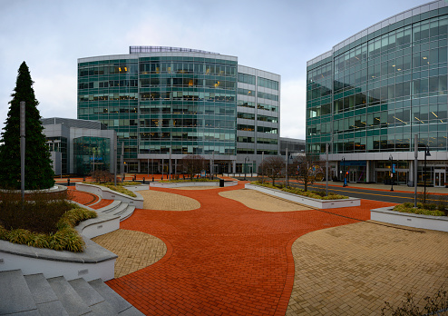 Modern metropolitan architecture of office apartment buildings with curving visually pleasing and convenient open entrance garden in New England, USA