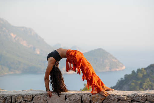 Athletic mid adult woman practicing meditative yoga in nature, Adrasan Antalya, Turkiye