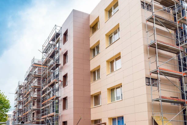 apartment building under construction with scaffolds.Scaffolding on multi storey building facade during renovation.