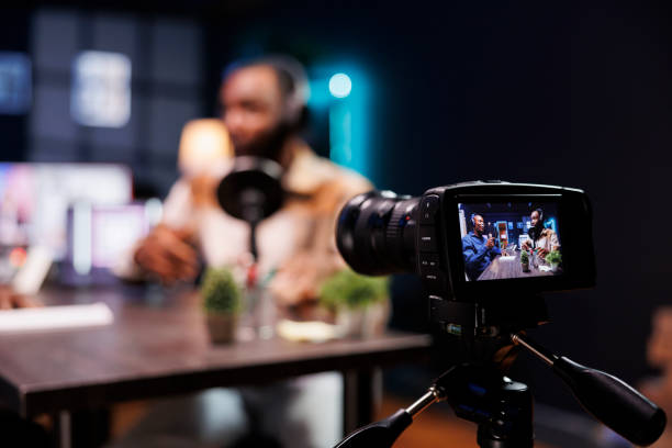 istock Camera filming talk show of black men 1972791850