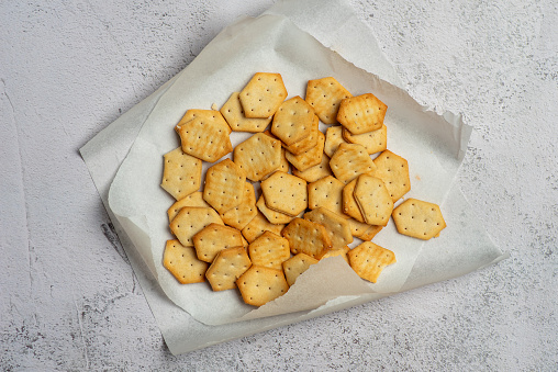 Delicious crispy crackers isolated on white. Top view