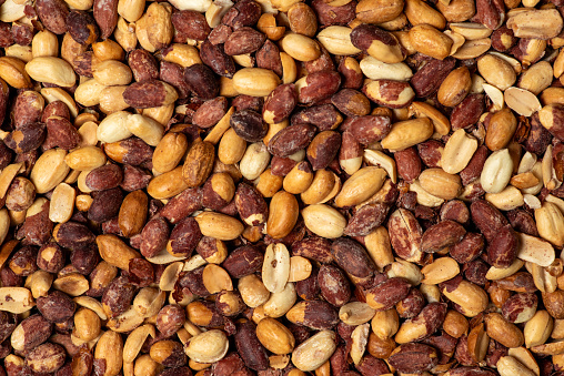 Background of roasted, salted peanuts. Full frame, close up