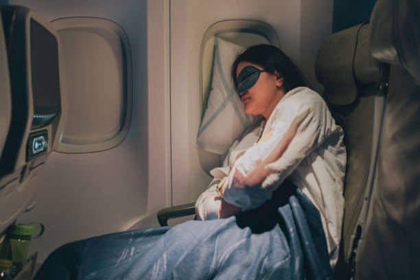 istock A woman wearing a sleep mask sleeping on a plane 1972794018