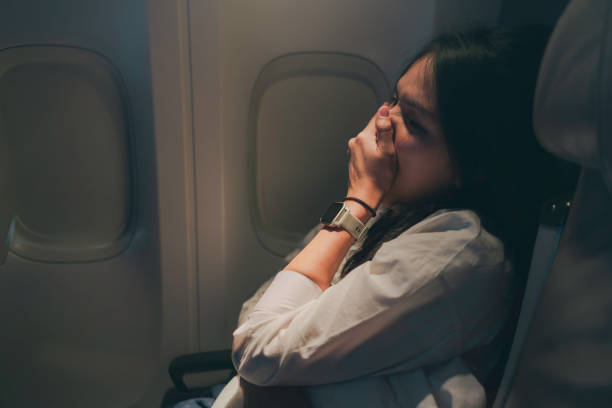 istock A woman yawning on a plane 1972795079