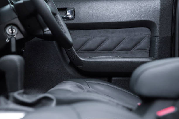 istock black interior of a modern car. Dashboard. Luxury leather steering wheel. Auto controls. Car doors inside. Car chairs and seats. Car sofa. Back and front row. Interior and door trim. High quality 1972798295