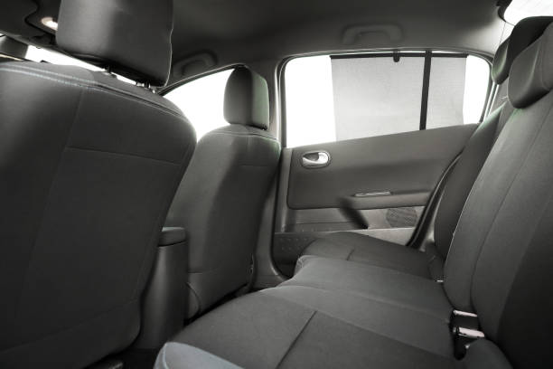 istock black interior of a modern car. Dashboard. Luxury leather steering wheel. Auto controls. Car doors inside. Car chairs and seats. Car sofa. Back and front row. Interior and door trim. High quality 1972798828