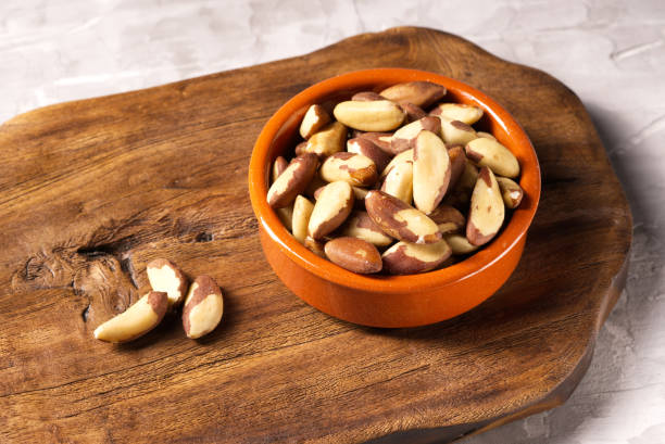 istock Brazil nut in ceramic bowl on a kitchen board. 1972799153