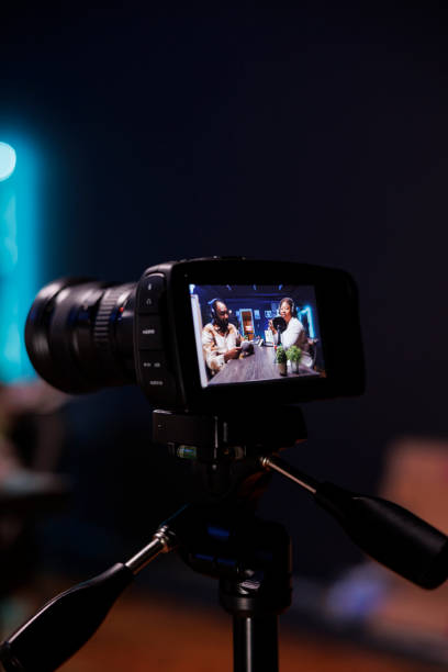 istock Camera on tripod filming live talk show 1972823549