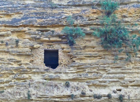 Photo of a window of a troglodyte house carved out of the magnificent Baou hill. This photograph was taken at Saint-Chamas in Provence.