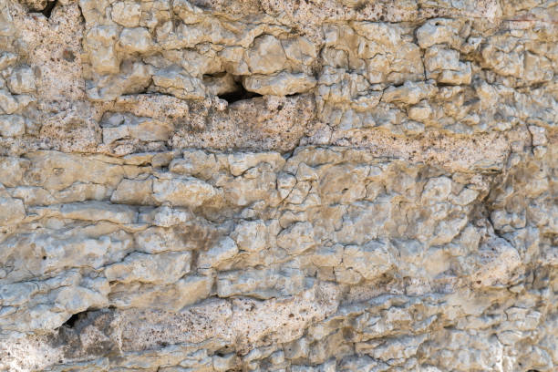 istock Old fortress wall made of natural stone as a structural background. 1972829861