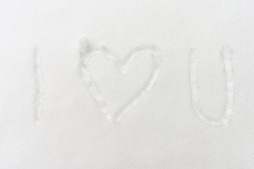 The inscription- I love you,and drawn heart in the snow, top view