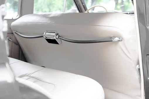 White interior. Car chairs and seats. Car sofa. Back and front row. Interior and door trim. Classic look. High quality
