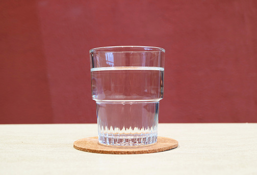 Closeup of a glass of drinking water isolated on white table