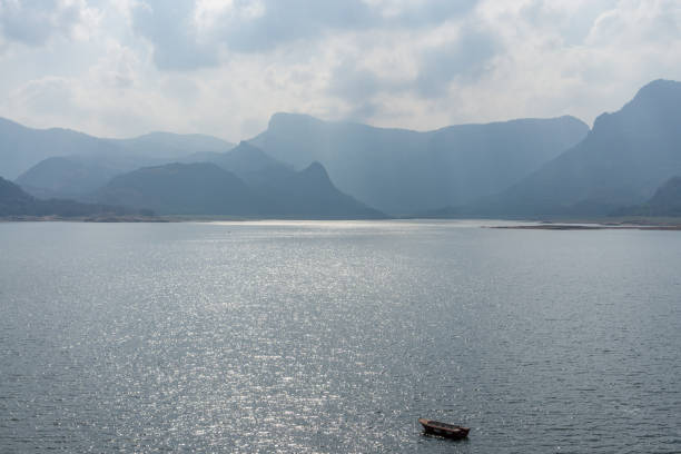 The Aliyar Dam reservoir with a single small boat.