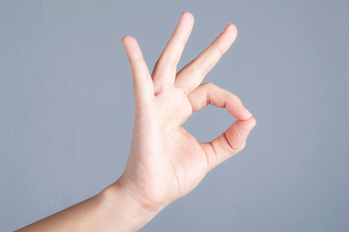 Hand Sign on gray background