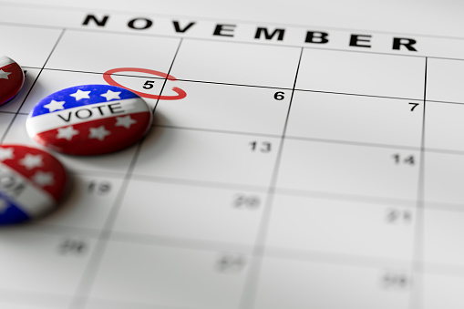 Get out and vote pins on 2024 November 5th calendar as reminder to vote in USA Presidential Election with copy space.