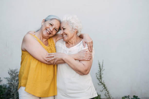 istock two happy senior woman standing embraced in front yard 1972918122
