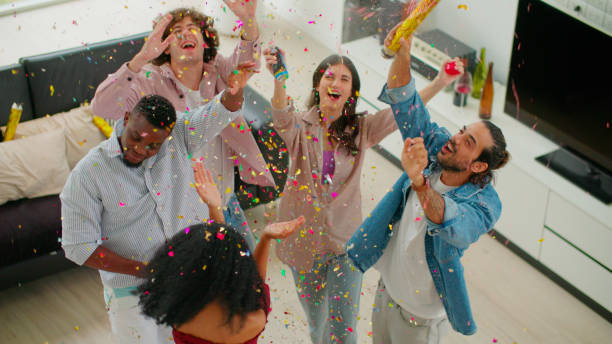 istock Joyful Multicultural Friends Celebrating Together with Confetti for Festive Occasions. 1972918131