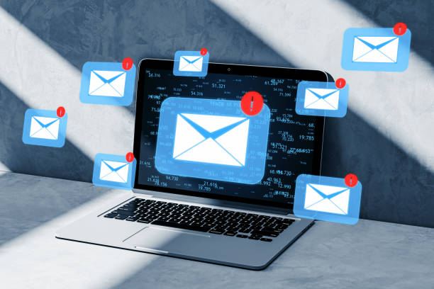 istock Laptop on office desk with email icons, forex data backdrop, and soft lighting. 3D Rendering 1972923425