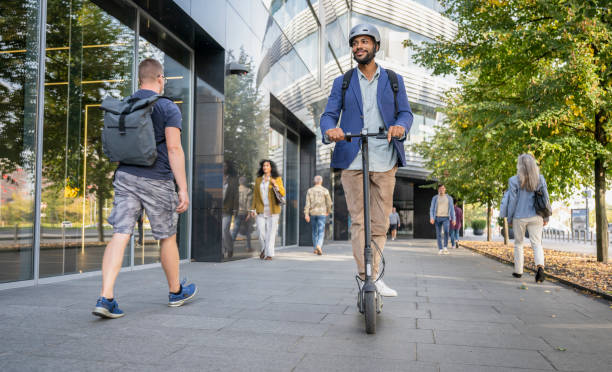 istock Well-Dressed Man Riding Electric Scooter 1972946268