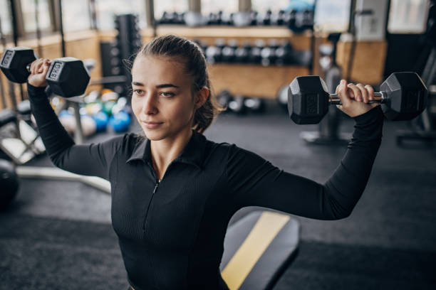 istock Woman exercising with dumbbells 1972962620
