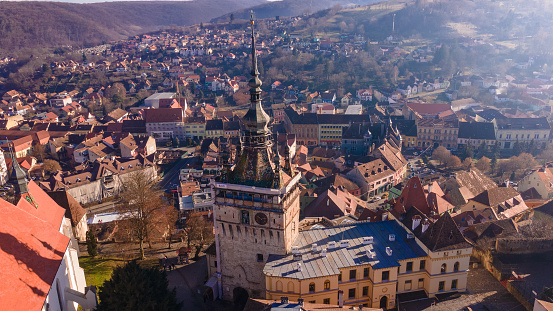 Birds eye view over Sighisoara city. Aerial photography of medieval city of Sighisoara from Romania, taken from a drone with the Clock Tower in the front.