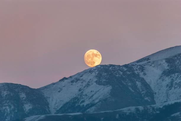 istock Full moon rising over a winter dream landscape 1972986920