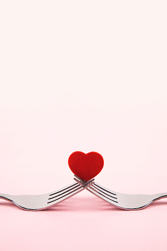 Valentine's Day concept with red boxes and hearts on pink light background. Flat lay. Greeting card with copy space.