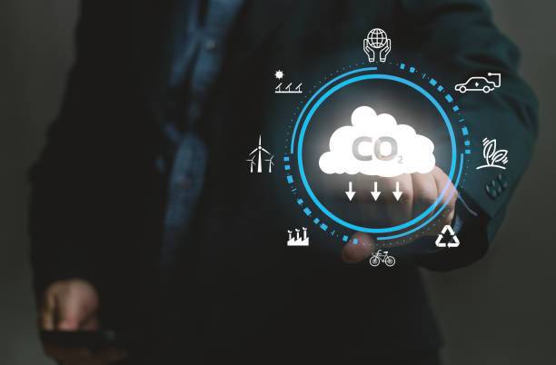 istock Businessman points at virtual screen with net zero emissions icon. Concept of net zero emissions and carbon neutrality. The renewable power sustainable. Global environmental climate warning. 1972990609