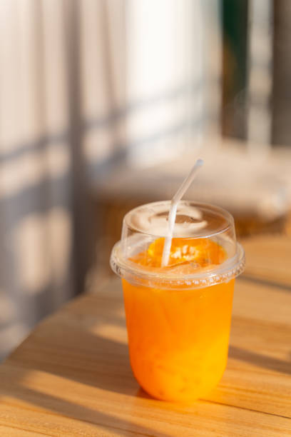 istock fresh orange juice in plastic glass 1973005636