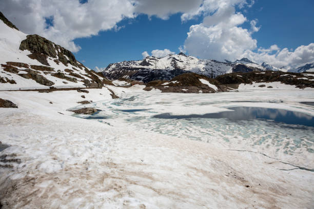 Totesee or Totensee at Grimsel Pass with melting snow at the first day open after winter. The Grimsel Pass is a mountain pass in Switzerland