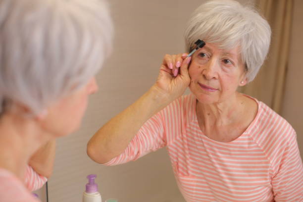 istock Senior woman combing her gorgeous eyebrows 1973009903