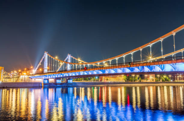 Krymsky Bridge or Crimean Bridge in Moscow at summer night. Steel suspension bridge in Moscow over the Moskva River