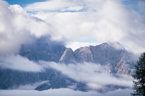 Dolomites Mountains covered in clouds in autumn season. Italy