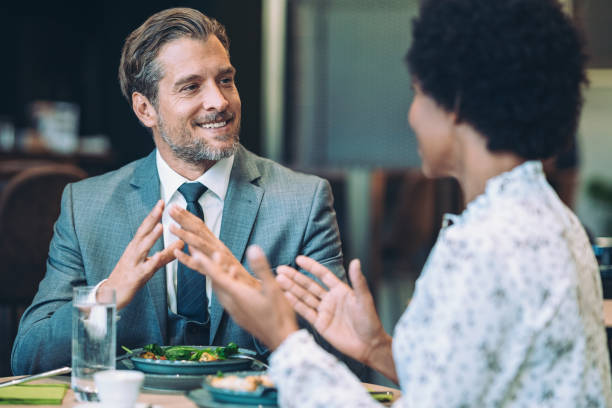 istock Couple of business persons talking during dinner 1973068146