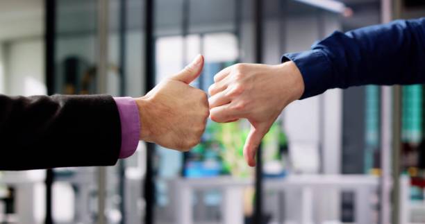 istock Businesspeople Hands Showing Thumb Up And Thumb Down 1973069491
