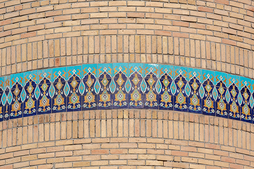Tile ornament at brick wall of minaret, close up pattern. Hazrati Imam mosque. Tashkent, Uzbekistan
