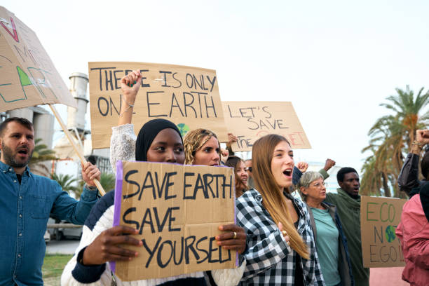 istock Group diverse activists people at demonstration against pollution factories angrily shouting slogan. 1973071666