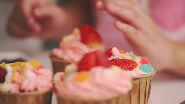 Decorate cupcakes with strawberries
