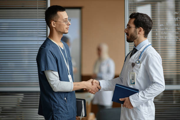 istock Two Male Medical Specialist Handshaking 1973071675
