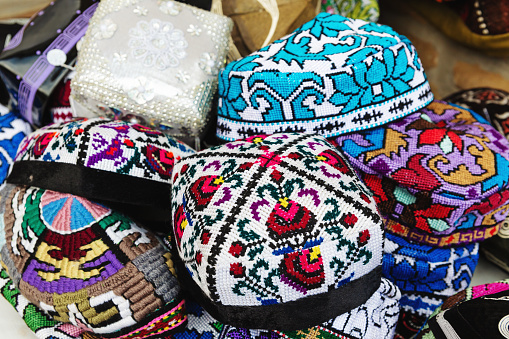 Multicolored Uzbek souvenir skullcaps (doppi or tubeteika) in market. Tashkent, Uzbekistan