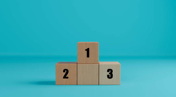 istock Wooden cubes as podium stand with first, second and third place. Wood blocks creative concept idea for business, winner, success, competition. 1973084819