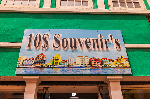 Curacao. Willemstad. 01.30.2024. View of vibrant painting above the entrance of a souvenir shop featuring inexpensive goods, depicting the colorful facades of Willemstad.