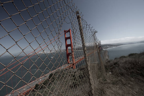 istock Peering at the Golden Gate Bridge through a hole in a fence 1973109753