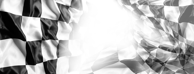 Checkered black and white racing flags on white. Copy space