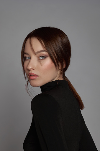 Studio shot of a beautiful young woman posing with glitter on her body